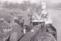 Photo showing how the coal cars were loaded by using freight cars as a buffer so that the weight of the train's engine was kept off the vessel.