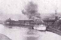 An overview of the Genesee Docks, c. 1925, with a vessel being loaded from the coal trestle built by the railroad in 1909 to load other coal carrying vessels.
